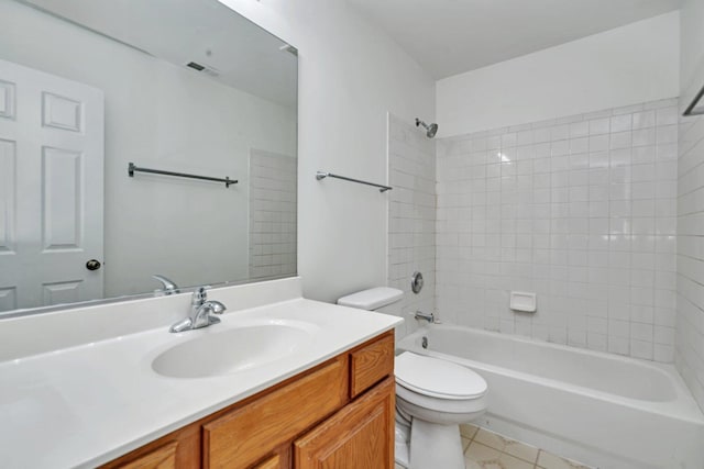 full bathroom featuring tiled shower / bath combo, vanity, and toilet