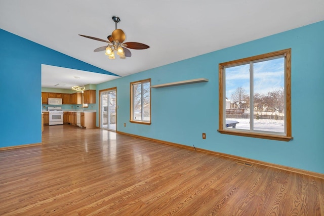 unfurnished living room with ceiling fan, vaulted ceiling, and light hardwood / wood-style flooring