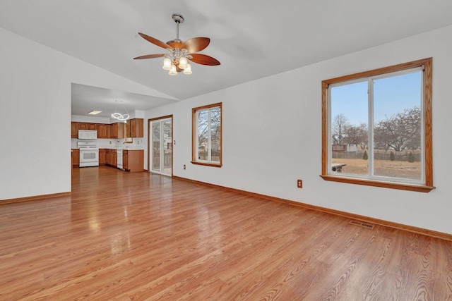 unfurnished living room with ceiling fan, lofted ceiling, and light hardwood / wood-style flooring