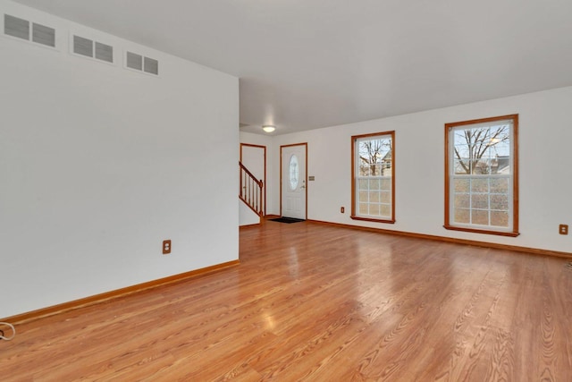 spare room with light wood-type flooring