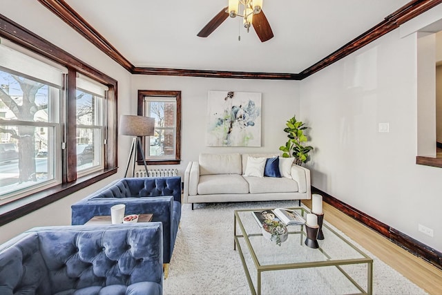 living room with ceiling fan, ornamental molding, and hardwood / wood-style flooring