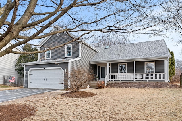 view of front of property featuring covered porch and a garage