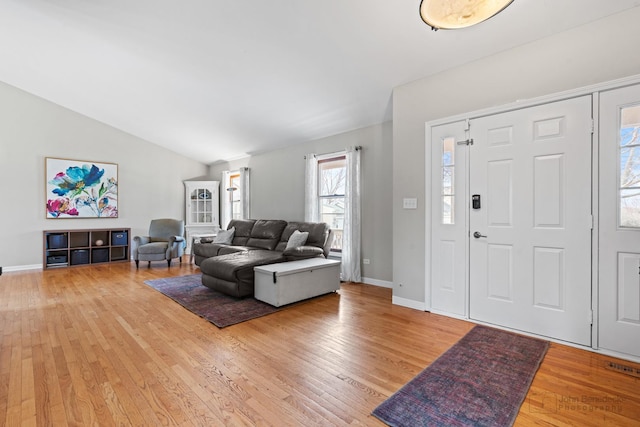 foyer entrance featuring light hardwood / wood-style flooring and lofted ceiling