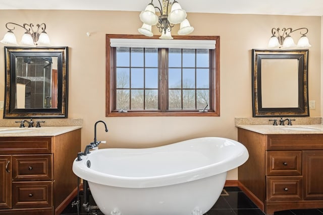 full bath featuring a soaking tub, two vanities, and a sink