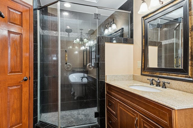 bathroom with a shower stall and vanity