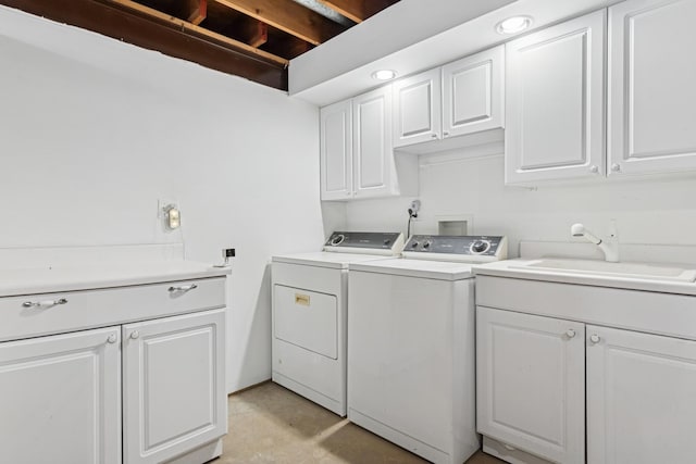 laundry room featuring a sink, cabinet space, and washer and dryer