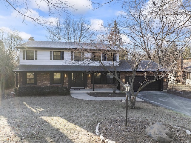 view of front of home with covered porch and a garage