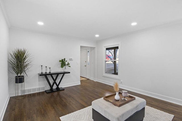 living area featuring dark hardwood / wood-style flooring and ornamental molding