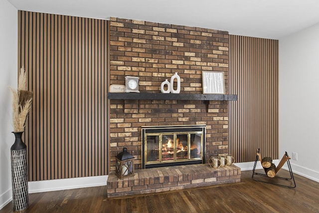 interior details with hardwood / wood-style flooring and a brick fireplace