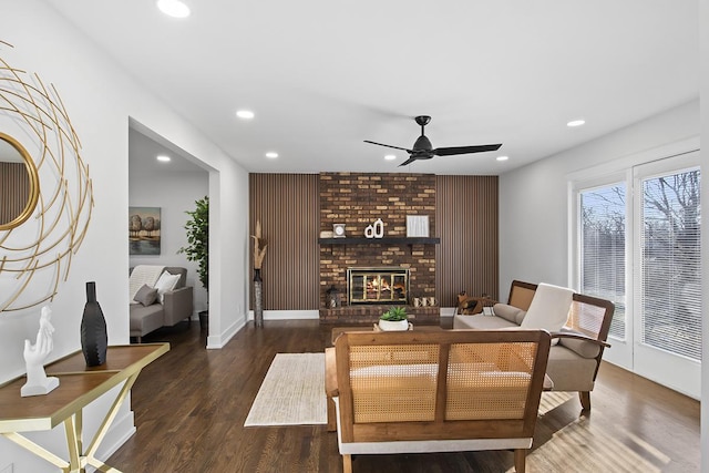 dining area with a fireplace, dark hardwood / wood-style flooring, and ceiling fan