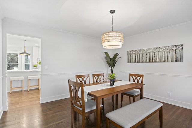 dining area featuring dark hardwood / wood-style floors and crown molding