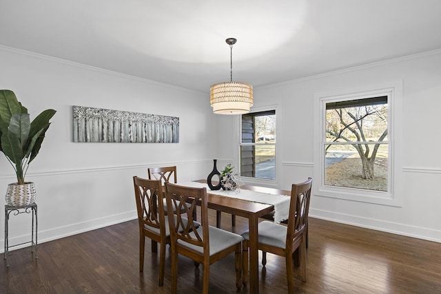 dining room with dark hardwood / wood-style flooring and ornamental molding