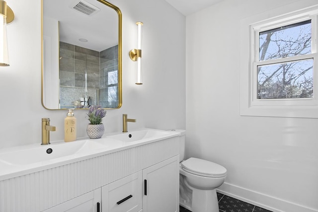 bathroom with tile patterned floors, vanity, and toilet