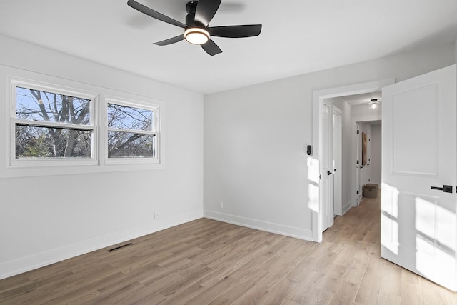 empty room featuring ceiling fan and light hardwood / wood-style floors