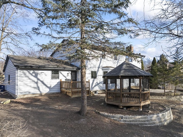 rear view of property featuring a deck