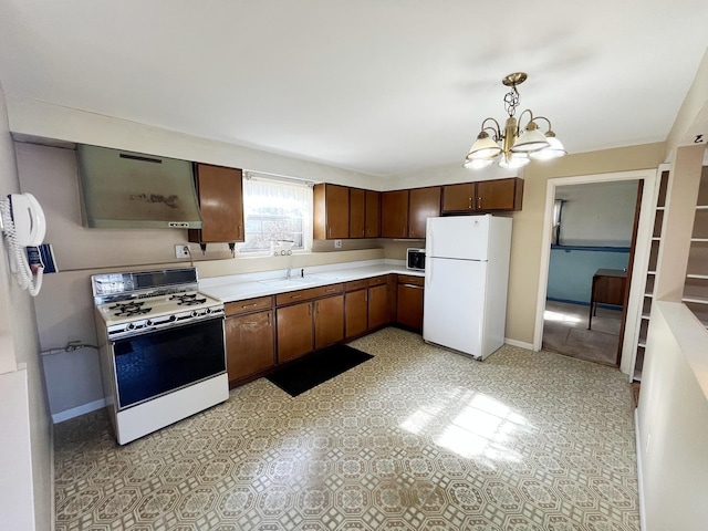 kitchen with a chandelier, white appliances, and decorative light fixtures