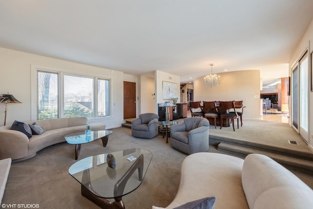 living room with a notable chandelier and carpet