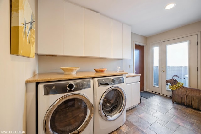 laundry room featuring cabinets and washer and clothes dryer