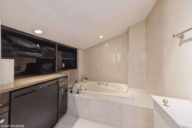 bathroom with vaulted ceiling, tiled bath, and tile patterned floors