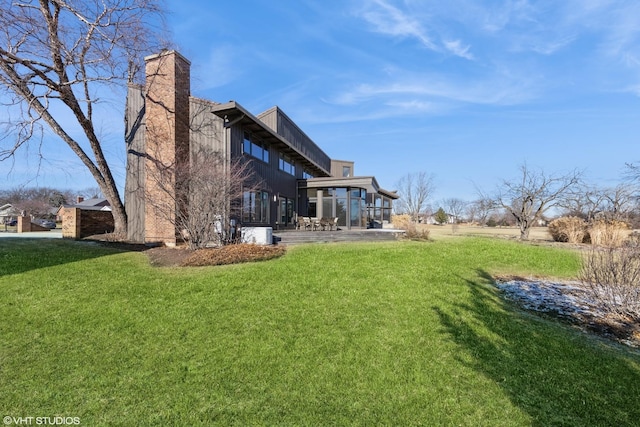 back of property with a yard and a patio area