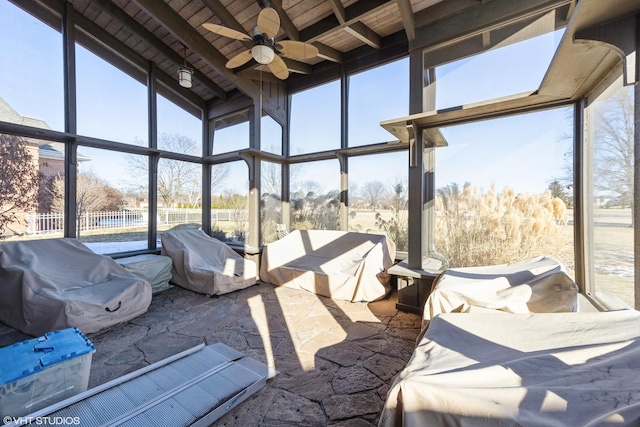 sunroom / solarium with beamed ceiling, ceiling fan, and wood ceiling