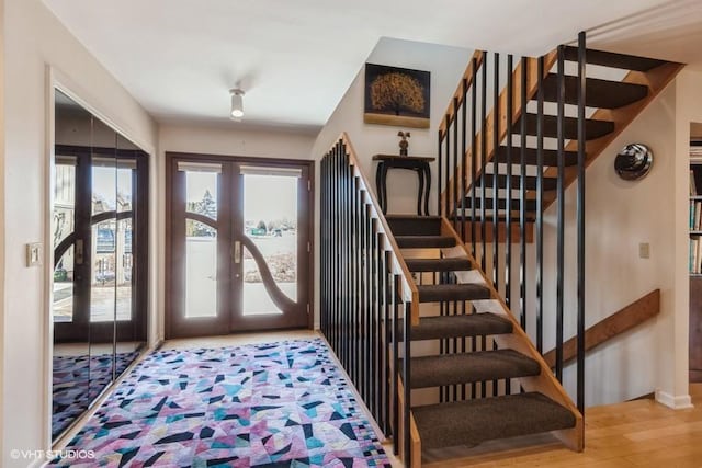 foyer entrance with french doors and wood-type flooring