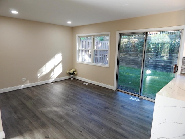 unfurnished room with dark hardwood / wood-style floors