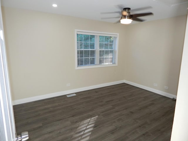 spare room featuring dark hardwood / wood-style floors and ceiling fan