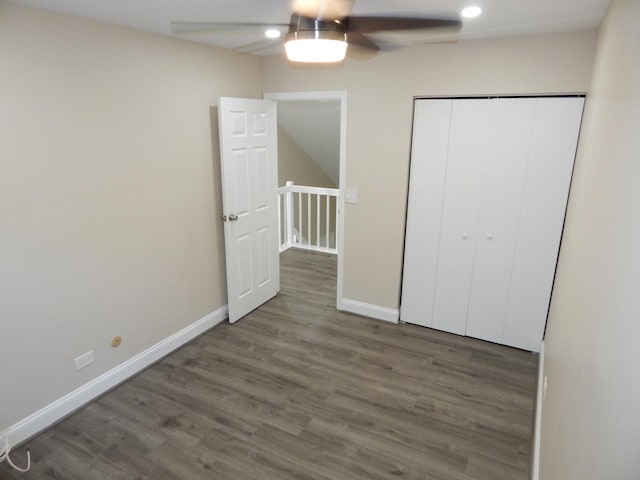 unfurnished bedroom featuring ceiling fan, dark hardwood / wood-style flooring, and a closet