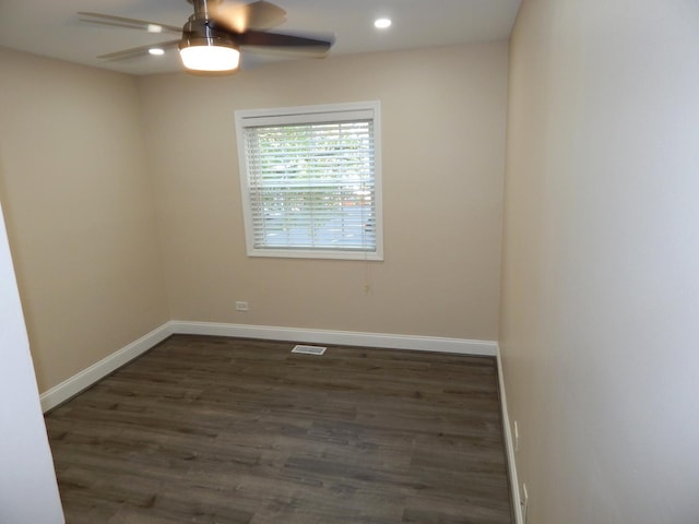 empty room featuring ceiling fan and dark hardwood / wood-style flooring