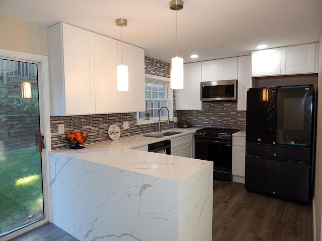 kitchen featuring black appliances, sink, decorative light fixtures, light stone counters, and white cabinetry