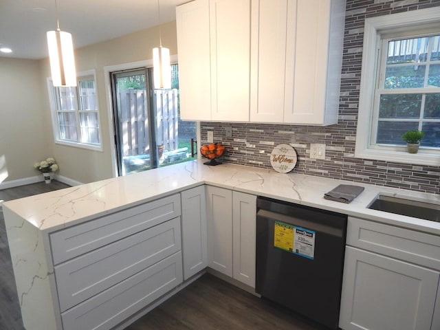 kitchen with light stone countertops, black dishwasher, kitchen peninsula, pendant lighting, and white cabinets