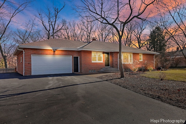 ranch-style home featuring a garage