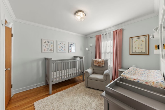 bedroom with ornamental molding and light hardwood / wood-style flooring