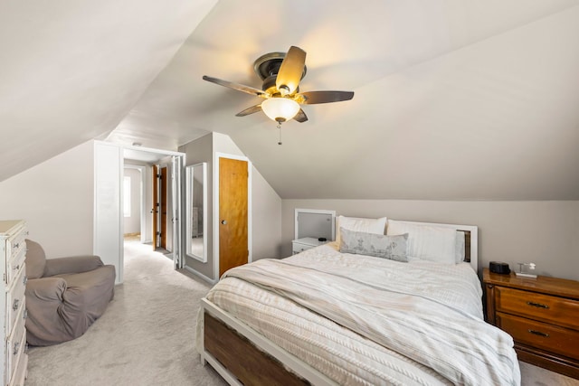 carpeted bedroom featuring lofted ceiling and ceiling fan