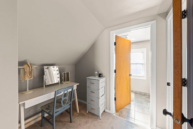 office with lofted ceiling and light colored carpet