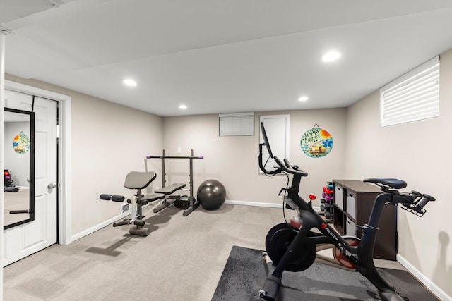 workout area featuring light carpet