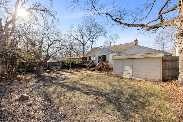 exterior space featuring a storage shed, a yard, and a deck