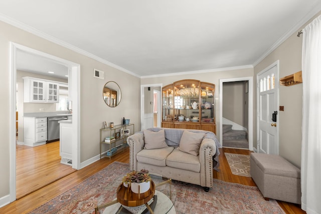 living room featuring crown molding and light wood-type flooring