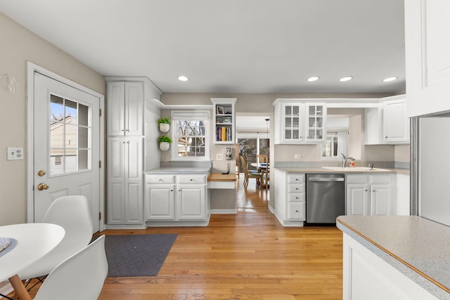 kitchen featuring white cabinets, light hardwood / wood-style flooring, and dishwasher