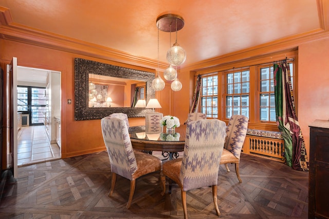 dining area with radiator, a healthy amount of sunlight, and parquet flooring