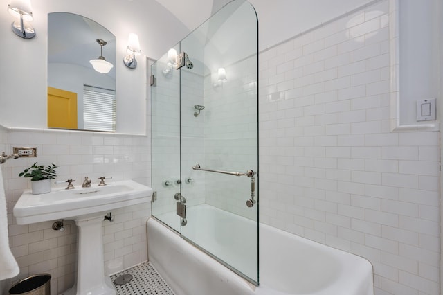 bathroom featuring tile patterned floors, shower / bath combination with glass door, and tile walls