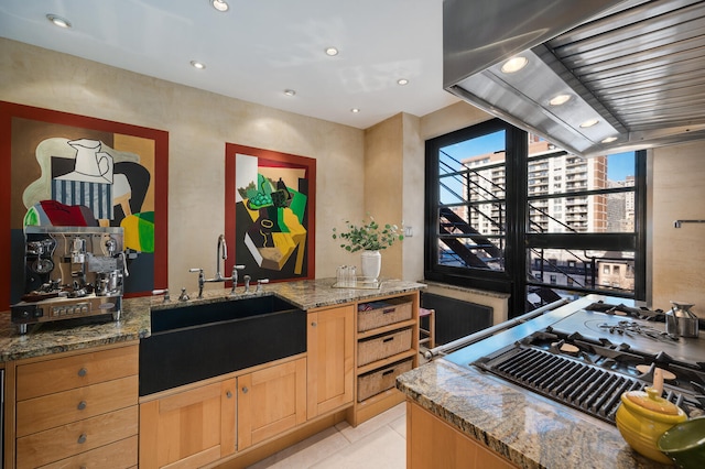 kitchen featuring exhaust hood, sink, light tile patterned floors, light stone countertops, and stainless steel gas cooktop