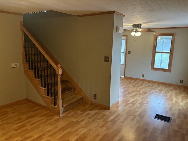 interior space featuring crown molding, ceiling fan, and wood-type flooring