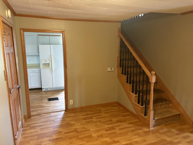 staircase with hardwood / wood-style flooring and crown molding