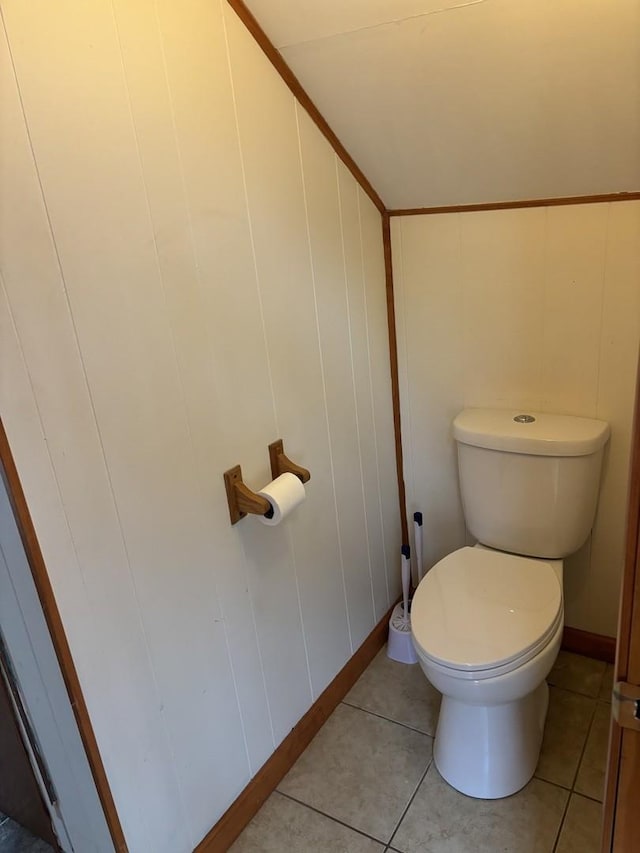 bathroom with tile patterned floors, toilet, and lofted ceiling