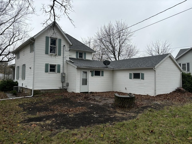 rear view of property with cooling unit