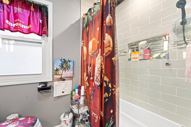 bathroom with toilet and shower / bath combo with shower curtain