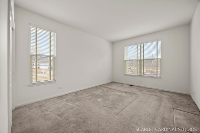 carpeted spare room with baseboards