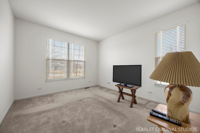 sitting room featuring carpet and baseboards